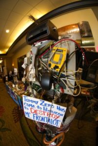 Booth with random computer parts displaying a sign